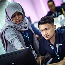woman in hijab teaching male employee