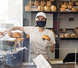 woman working in bakery with mask on