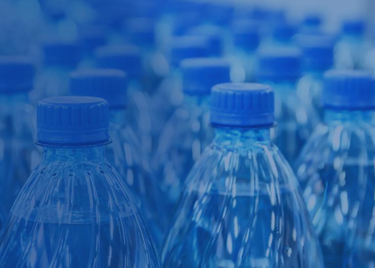 blue water bottles on conveyor in packaging facility